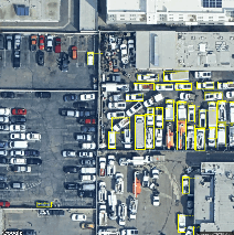 Fig 4b. Aerial view of a parking lot with cars and buildings